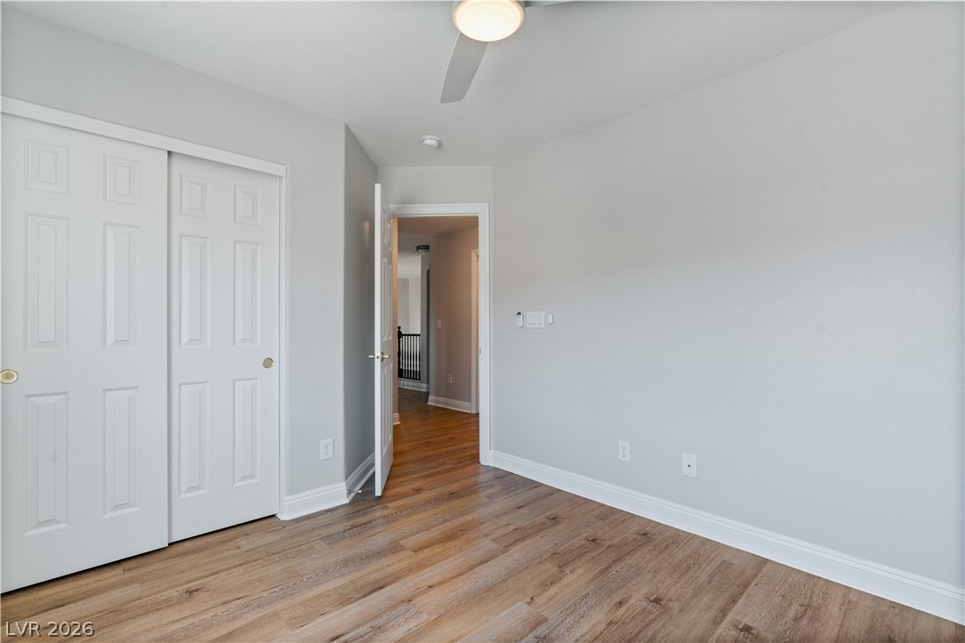 1328 Spice Ridge Court Henderson, NV 89012 - Photo 30 of 51 This spacious 2nd bedroom features wood flooring, a ceiling fan, and ample natural light.