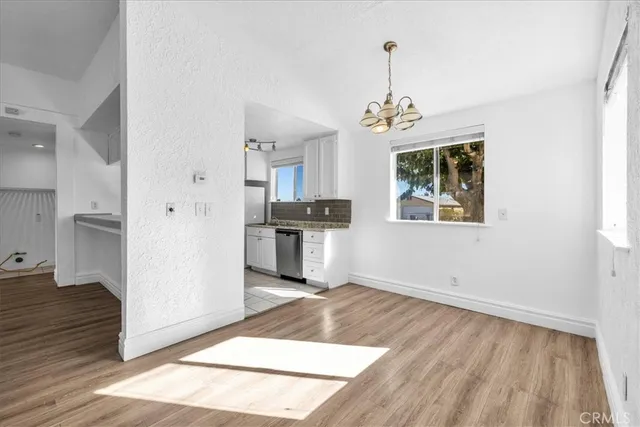 a kitchen with a sink stainless steel appliances a counter top space and cabinets