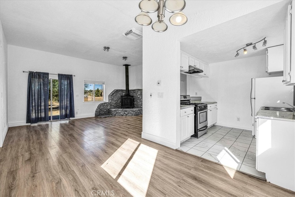 6686 Mojave Avenue Twentynine Palms, CA 92277 - Photo 13 of 41 a kitchen with a sink stainless steel appliances a counter top space and cabinets