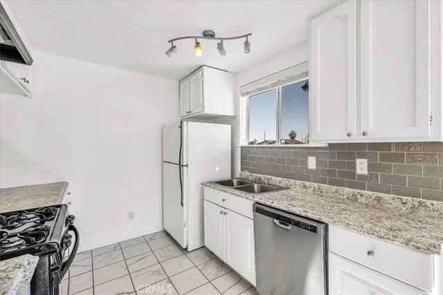 a kitchen that has a sink and a stove