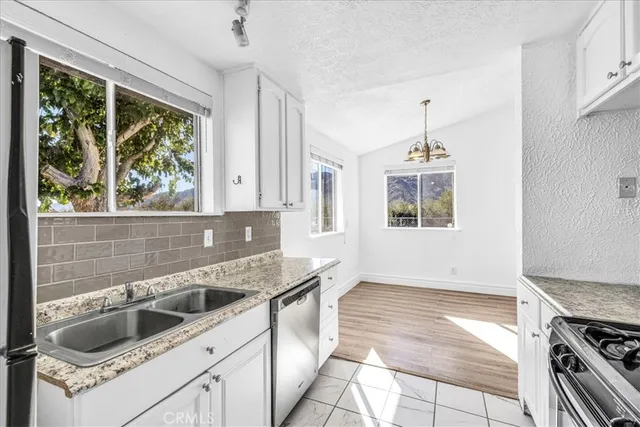 a kitchen with stainless steel appliances granite countertop a stove and a sink
