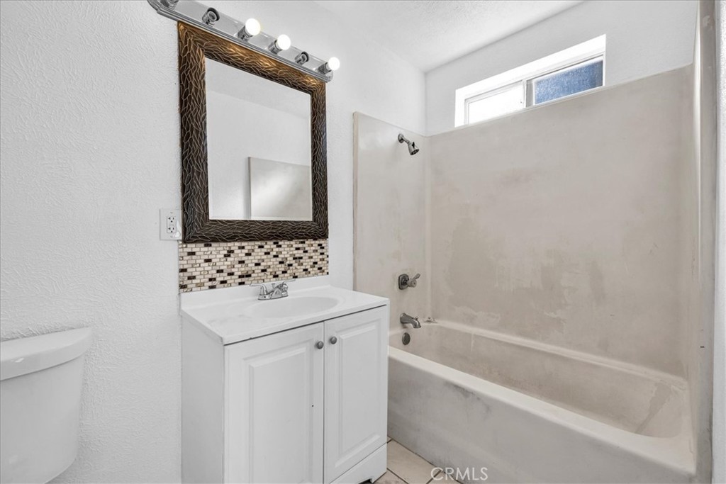 6686 Mojave Avenue Twentynine Palms, CA 92277 - Photo 22 of 41 a bathroom with a sink a toilet and shower