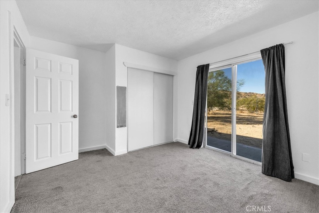 6686 Mojave Avenue Twentynine Palms, CA 92277 - Photo 24 of 41 an empty room with a sliding door