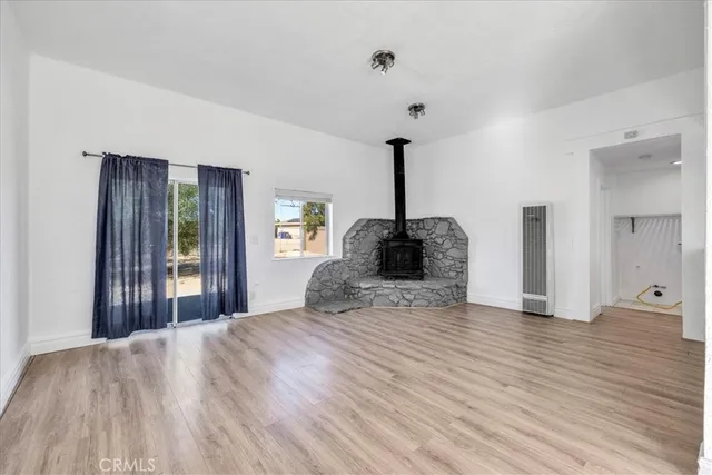 a view of a kitchen with wooden floor and a sink