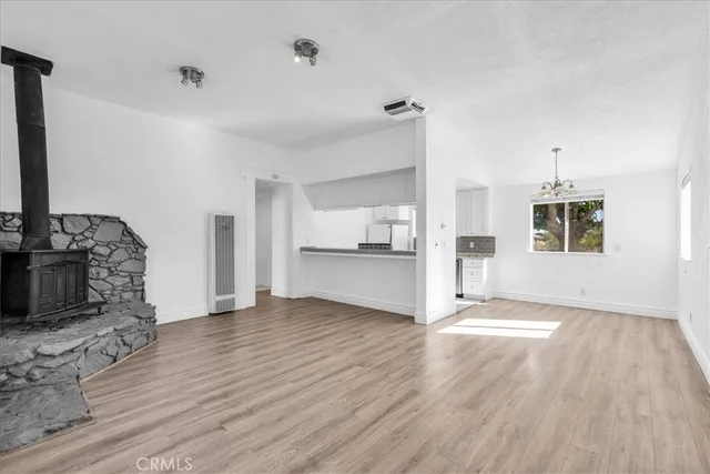 a view of a kitchen with wooden floor and electronic appliances