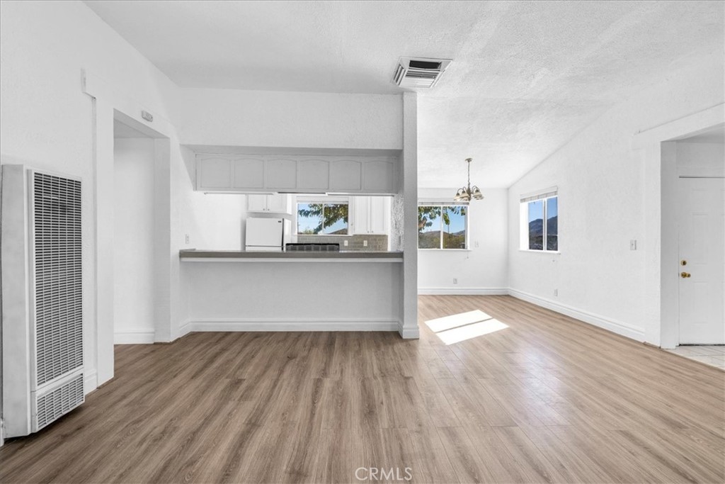 6686 Mojave Avenue Twentynine Palms, CA 92277 - Photo 9 of 41 a view of a kitchen with wooden floor and electronic appliances