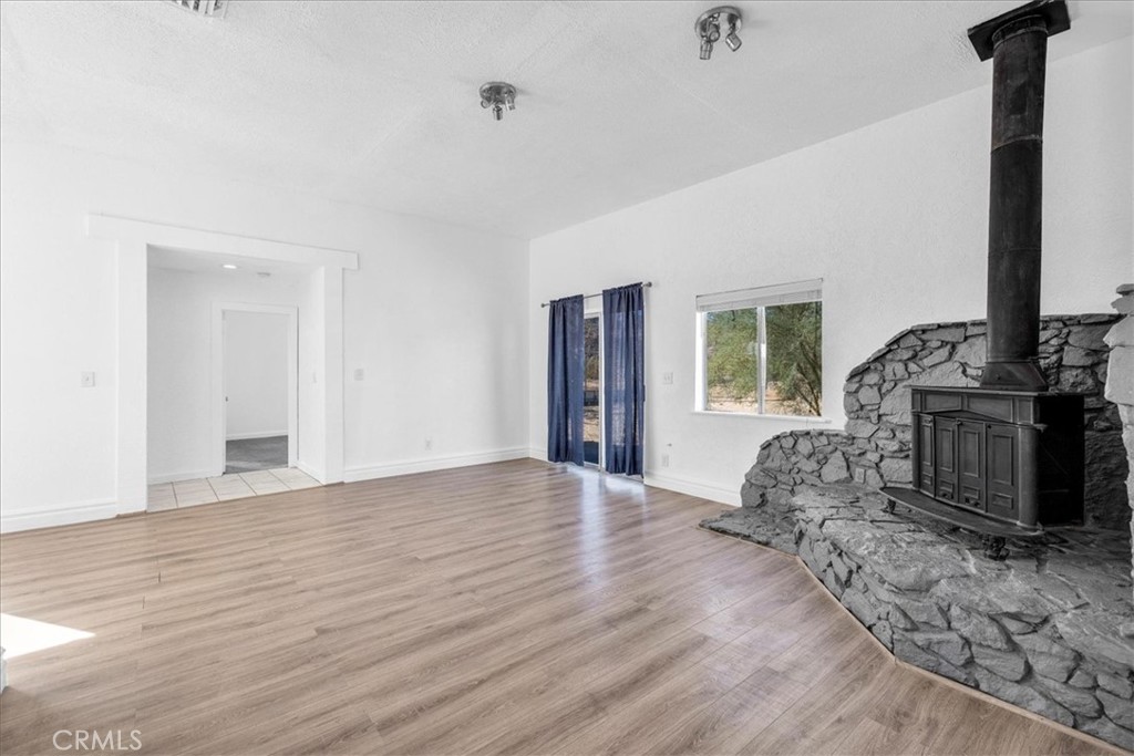 6686 Mojave Avenue Twentynine Palms, CA 92277 - Photo 10 of 41 a view of an empty room with wooden floor and a window