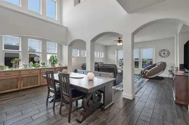 a kitchen with kitchen island stainless steel appliances a sink a stove a table and chairs