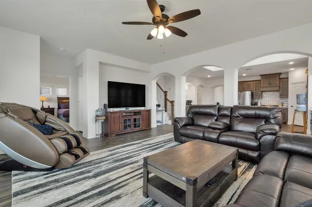 a living room with furniture and a chandelier