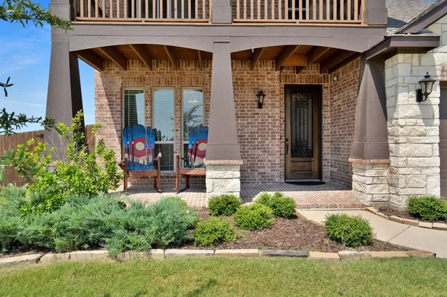 a view of a chair and tables in the patio of the house