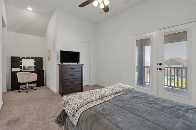 a spacious bedroom with a bed and a chandelier