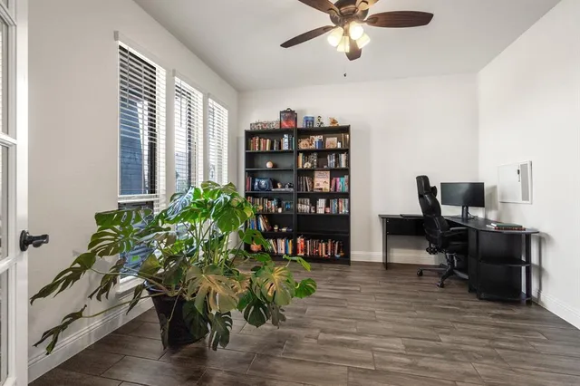 a view of a workspace with furniture and a potted plant
