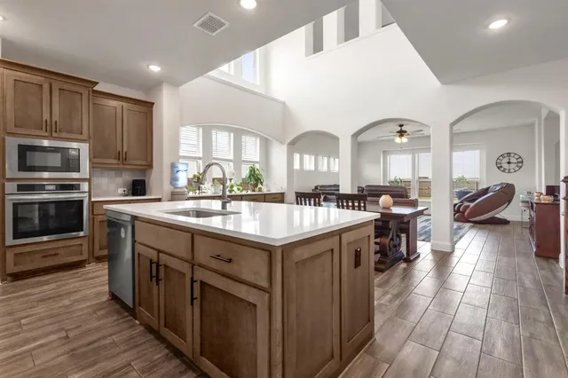 a kitchen with stainless steel appliances granite countertop a stove and a sink