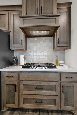 a stove top oven sitting inside of a kitchen