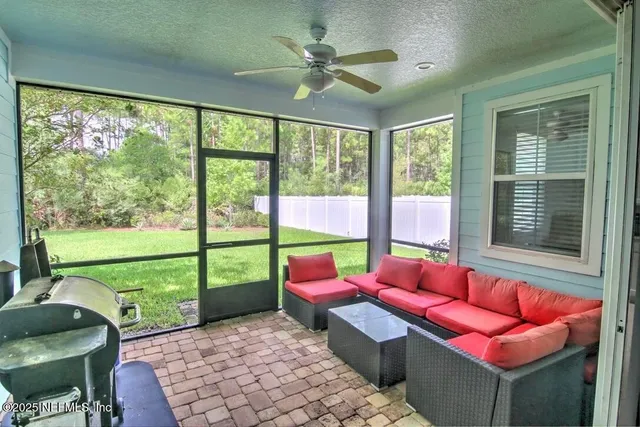 a living room with patio couch and a table