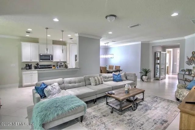 a living room with furniture and kitchen view