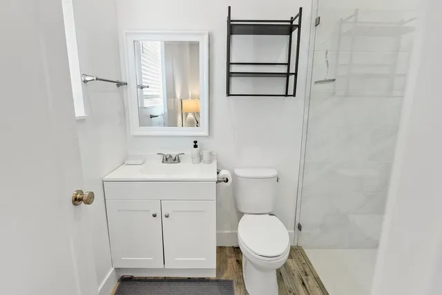 a bathroom with a sink toilet and shower