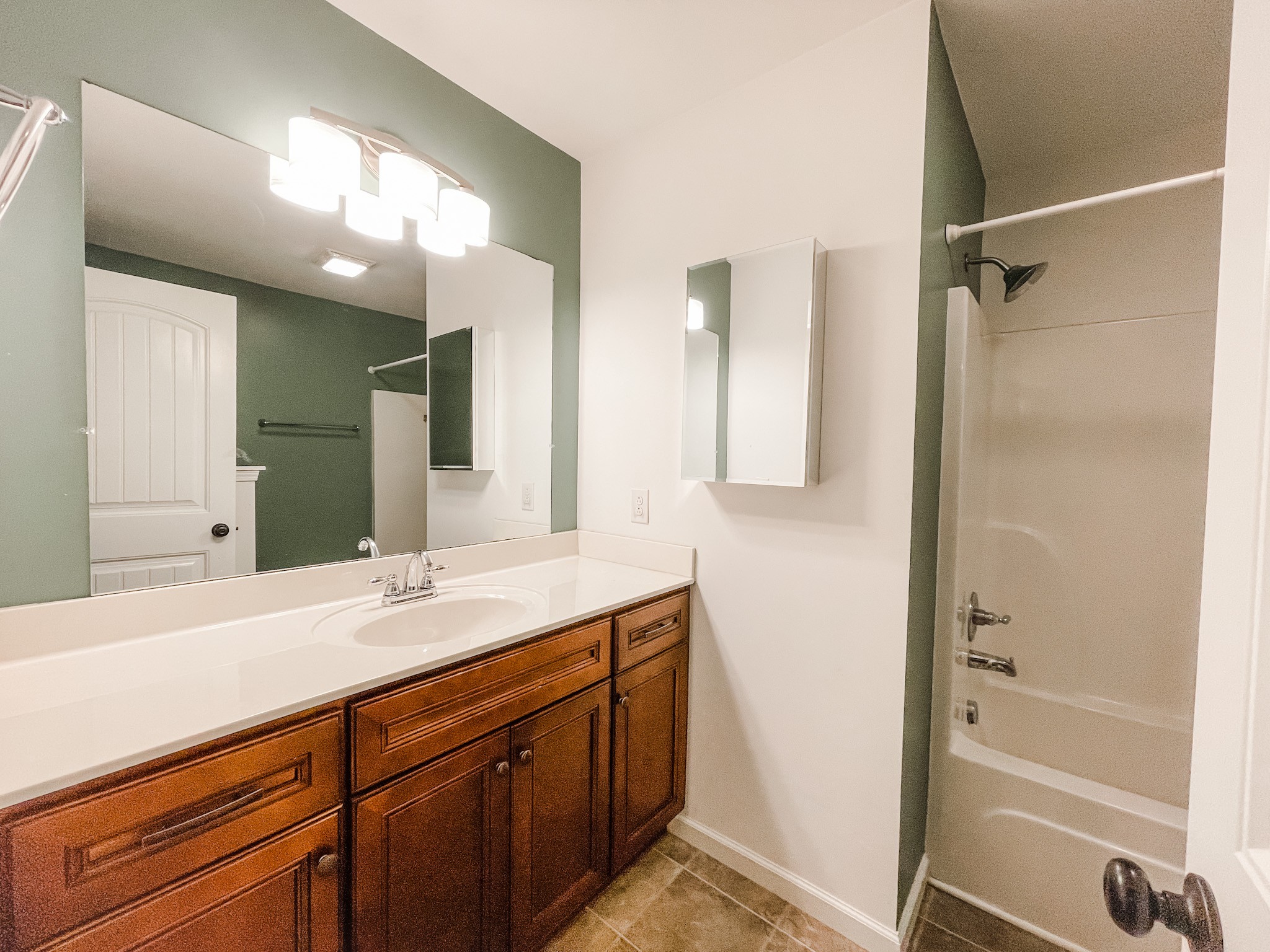 224 Shaub Road Portland, TN 37148 - Photo 16 of 23 a bathroom with a double vanity sink a mirror and a bathtub