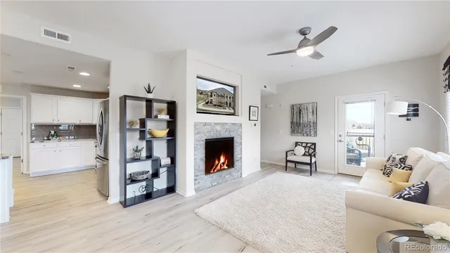 a living room with furniture and a fireplace