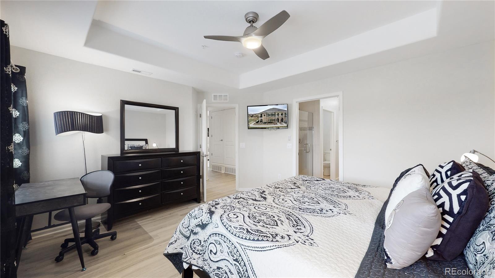 11331 Xavier Drive, Unit 103 Westminster, CO 80031 - Photo 17 of 30 a bedroom with a bed and a chandelier