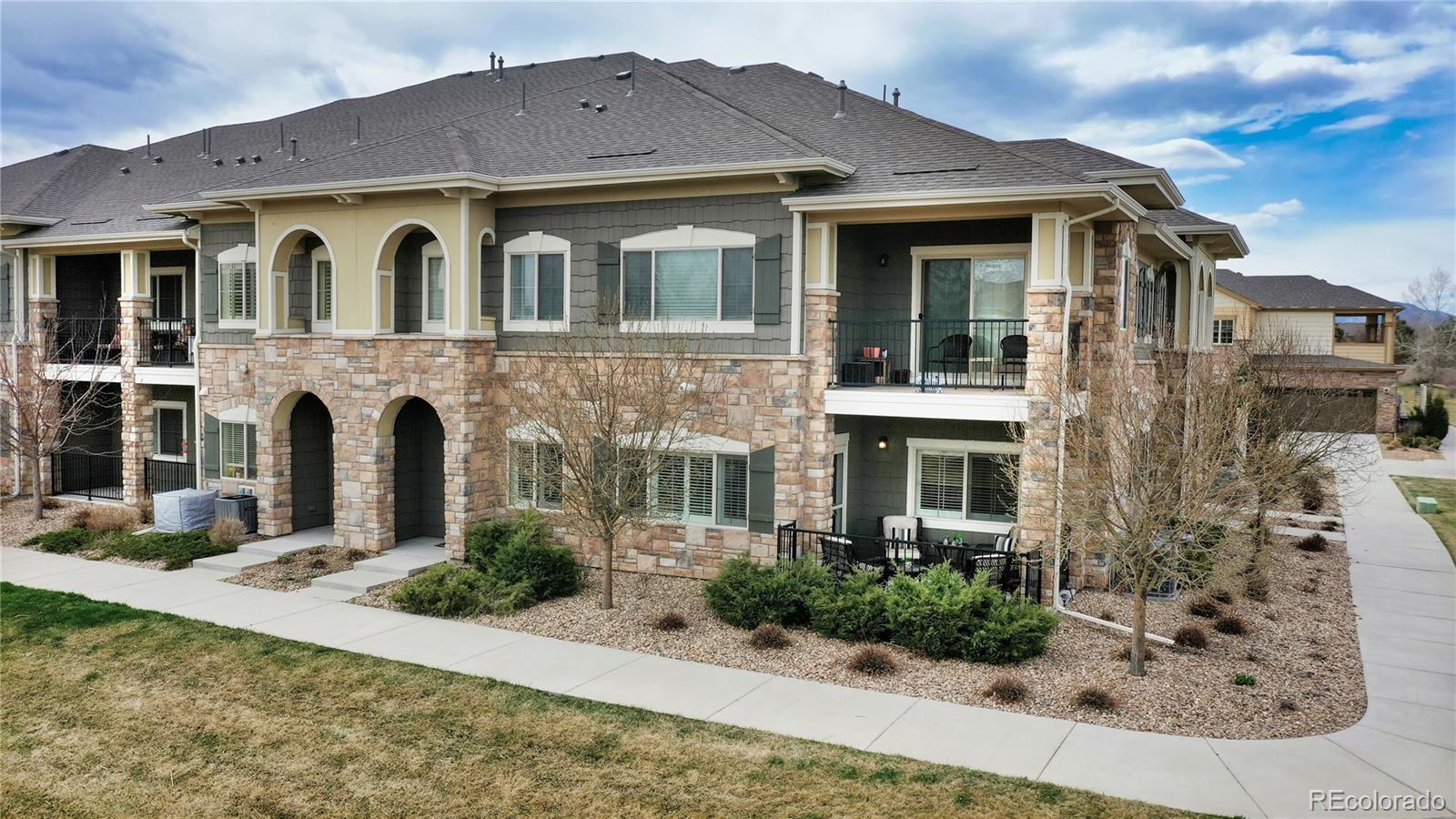 11331 Xavier Drive, Unit 103 Westminster, CO 80031 - Photo 2 of 30 a front view of a house with garden