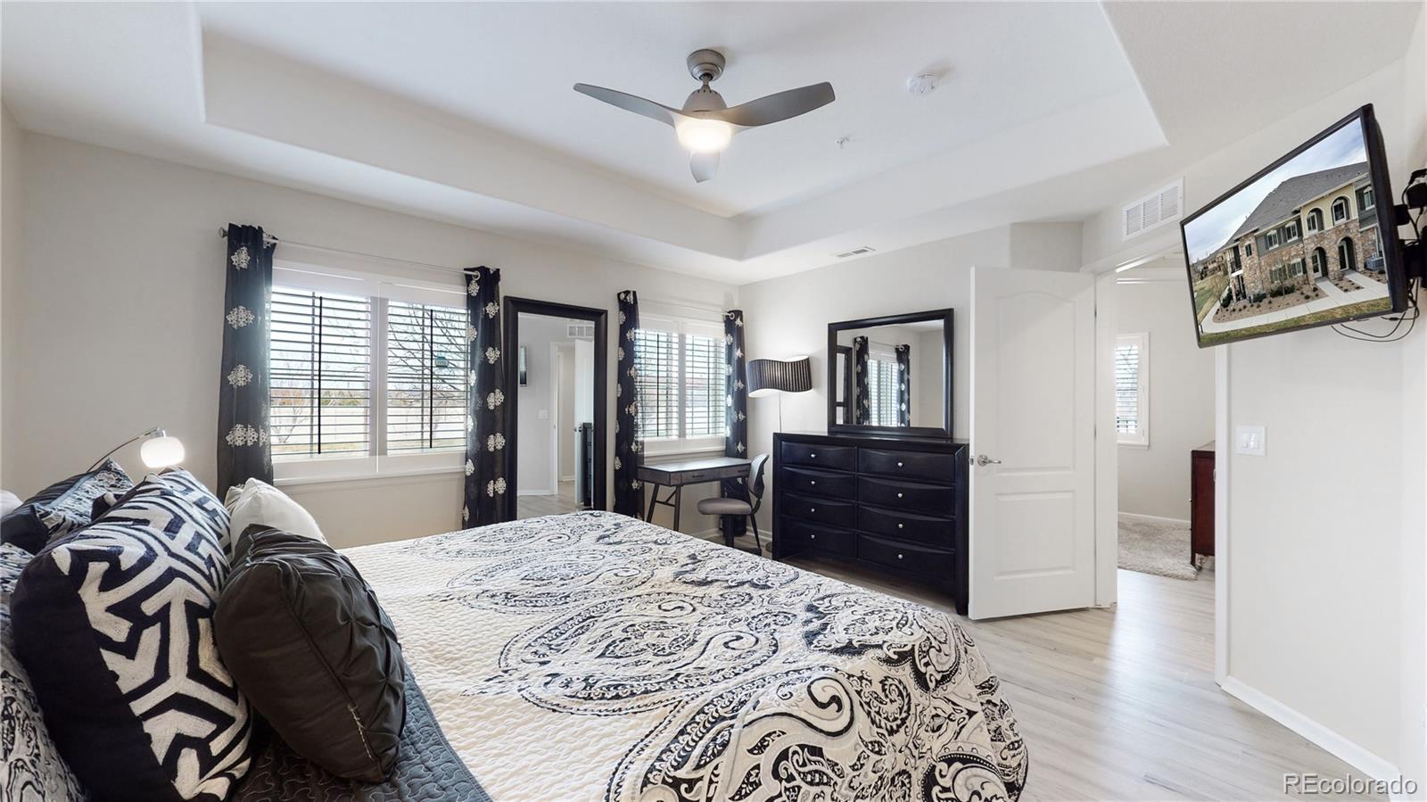 11331 Xavier Drive, Unit 103 Westminster, CO 80031 - Photo 21 of 30 a bed room with a bed and a dresser