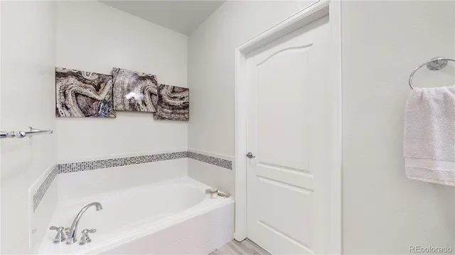 a black leather couch sitting next to a cabinet