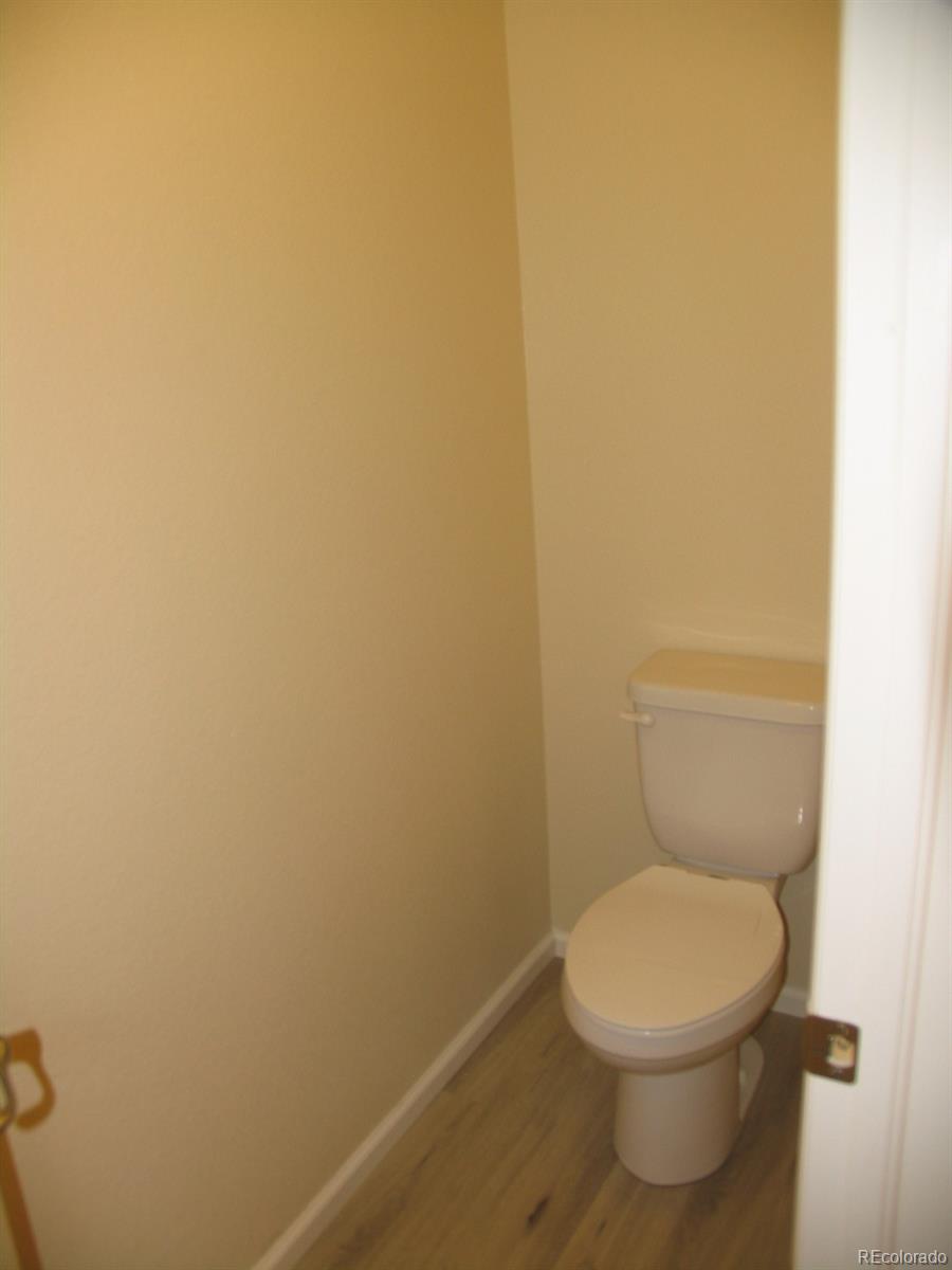 11331 Xavier Drive, Unit 103 Westminster, CO 80031 - Photo 25 of 30 a white toilet sitting next to a white wall