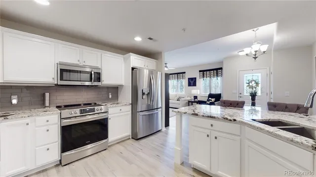 a kitchen with a sink stove and refrigerator
