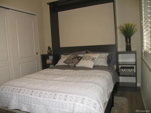 a bedroom with a bed and a potted plant