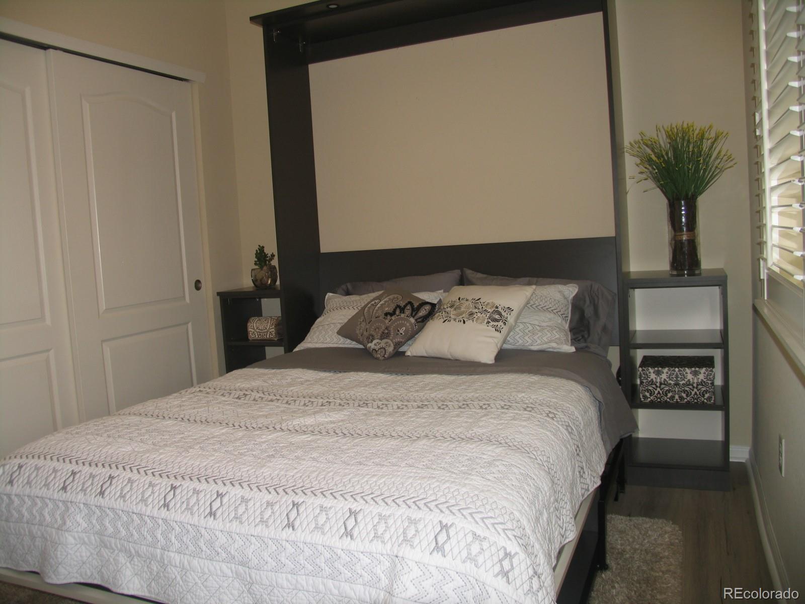 11331 Xavier Drive, Unit 103 Westminster, CO 80031 - Photo 6 of 30 a bedroom with a bed and a potted plant