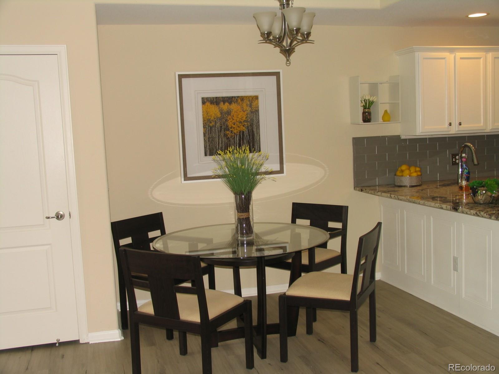 11331 Xavier Drive, Unit 103 Westminster, CO 80031 - Photo 10 of 30 a dining room with furniture and wooden floor