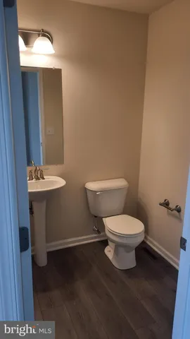 a white toilet sitting next to a bathroom sink