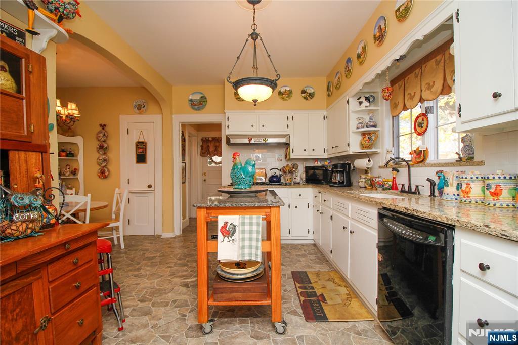 301 3rd Street Clifton, NJ 07011 - Photo 11 of 28 a kitchen with stainless steel appliances granite countertop a stove a sink and a refrigerator