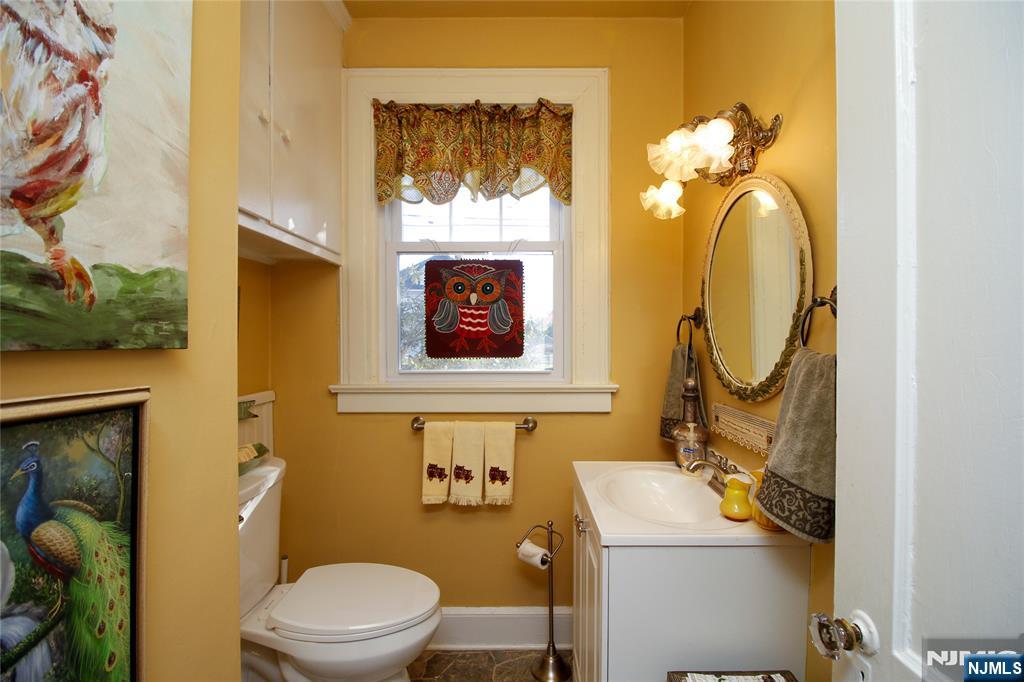 301 3rd Street Clifton, NJ 07011 - Photo 14 of 28 a bathroom with a toilet sink and mirror