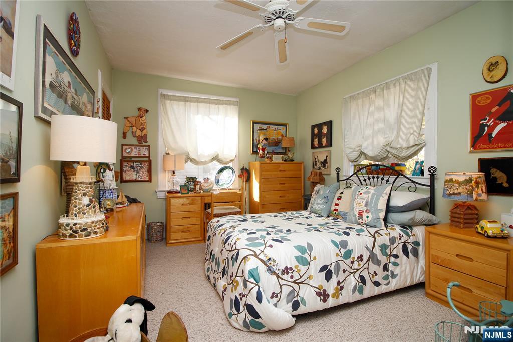 301 3rd Street Clifton, NJ 07011 - Photo 17 of 28 a bedroom with bed and a chandelier
