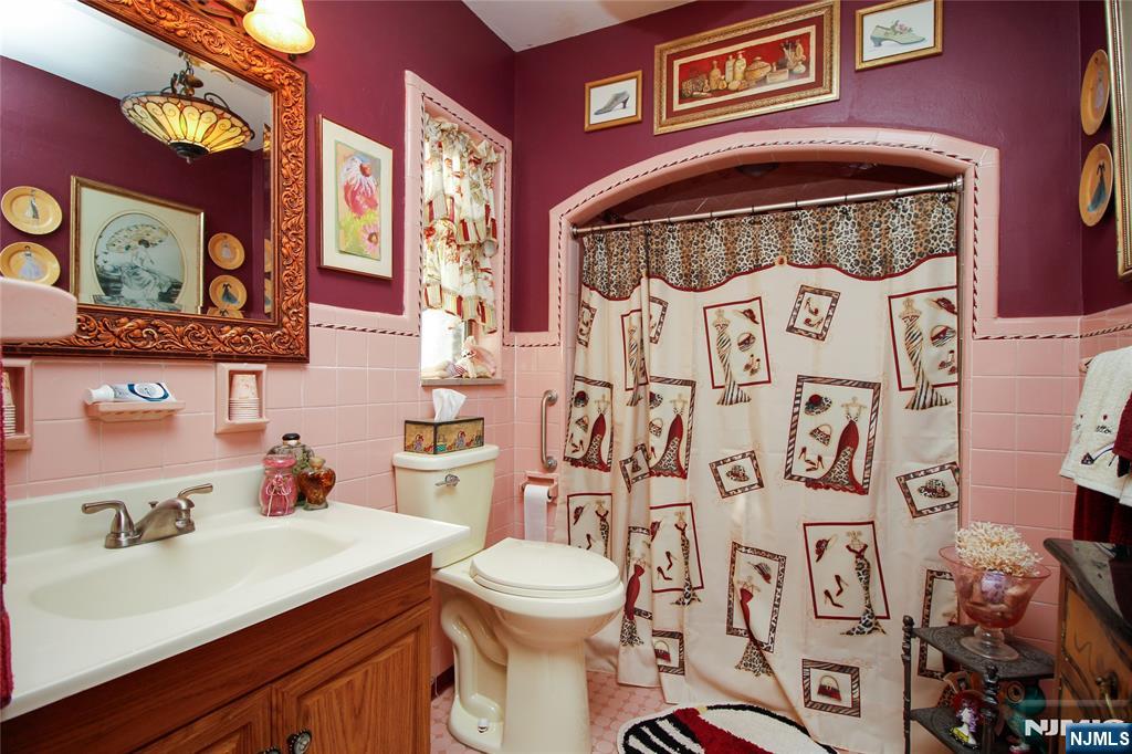 301 3rd Street Clifton, NJ 07011 - Photo 18 of 28 a bathroom with a sink and a mirror