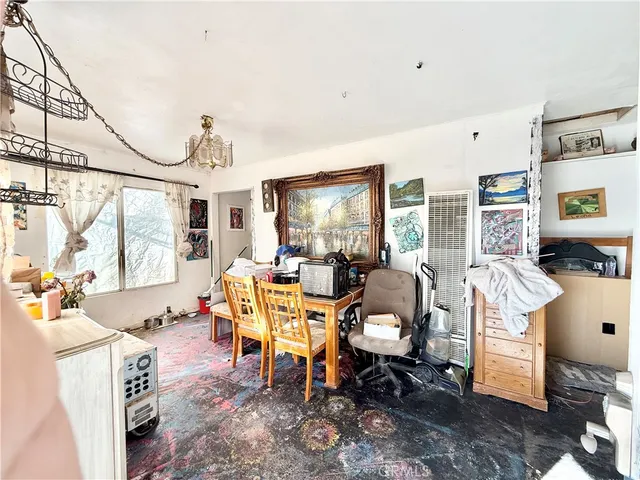 a living room with furniture windows and a table