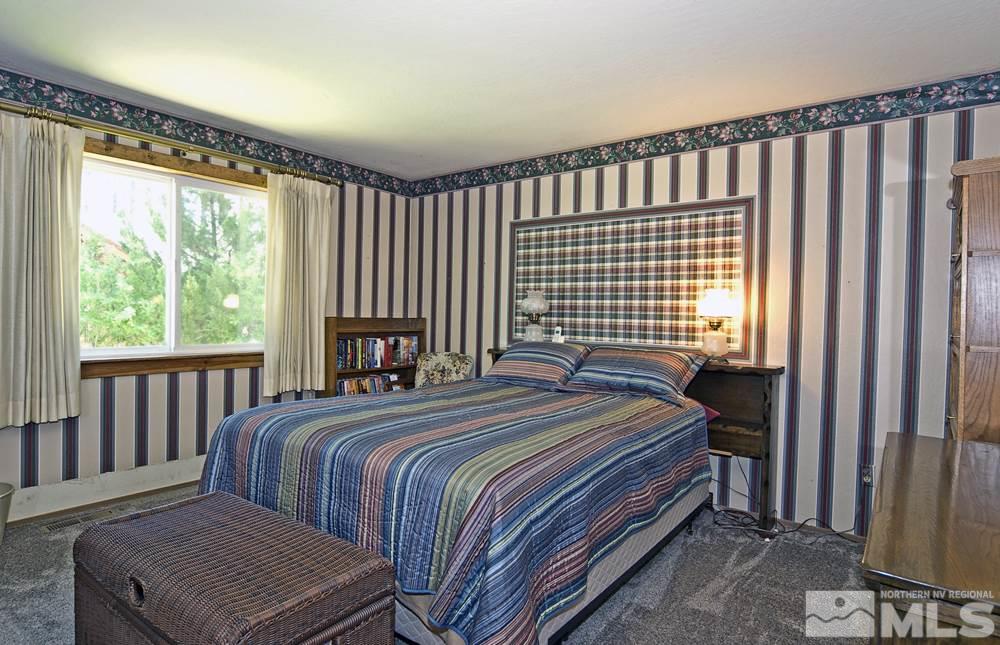 70 Pinon Road Markleeville, CA 96120 - Photo 17 of 25 a bedroom with a bed lamp and a window