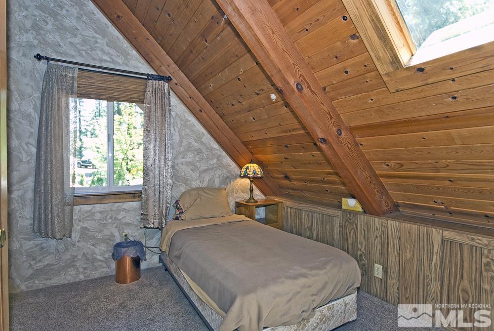 70 Pinon Road Markleeville, CA 96120 - Photo 20 of 25 a bedroom with a bed and wooden floor