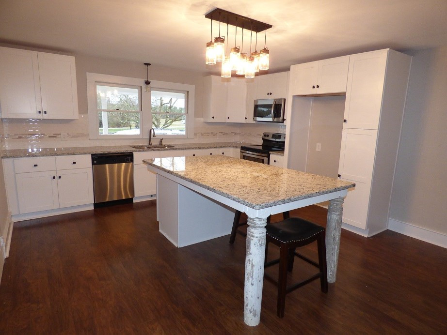 1770 Cooper Branch Road Clayton, NC 27520 - Photo 10 of 24 Features all-wood Shaker style cabinets w/soft closing drawers. custom island w/large granite slab, new double-pane windows w/warranty. Kitchen