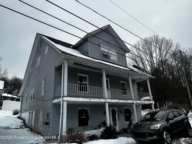a view of parked car in front of house