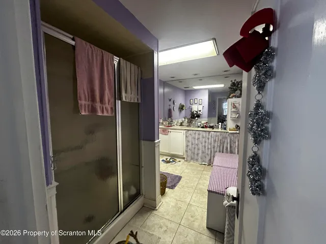 a room with furniture a flat screen tv and a large window