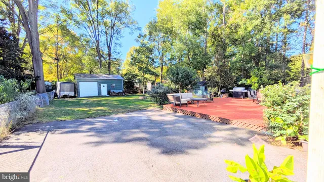 a backyard of a house with lots of green space and fountain