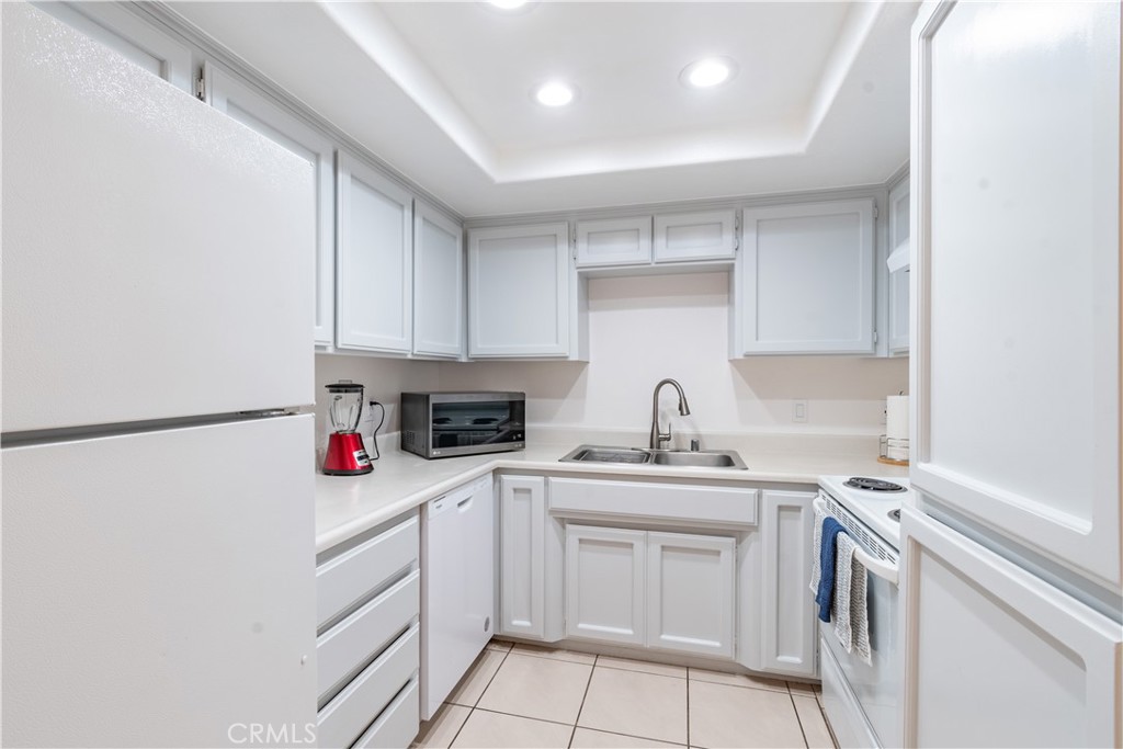 3121 Spring Street, Unit 106 Paso Robles, CA 93446 - Photo 4 of 10 a kitchen with a sink cabinets and white appliances