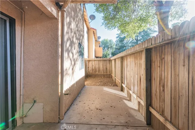 a view of a pathway of a building with wooden fence