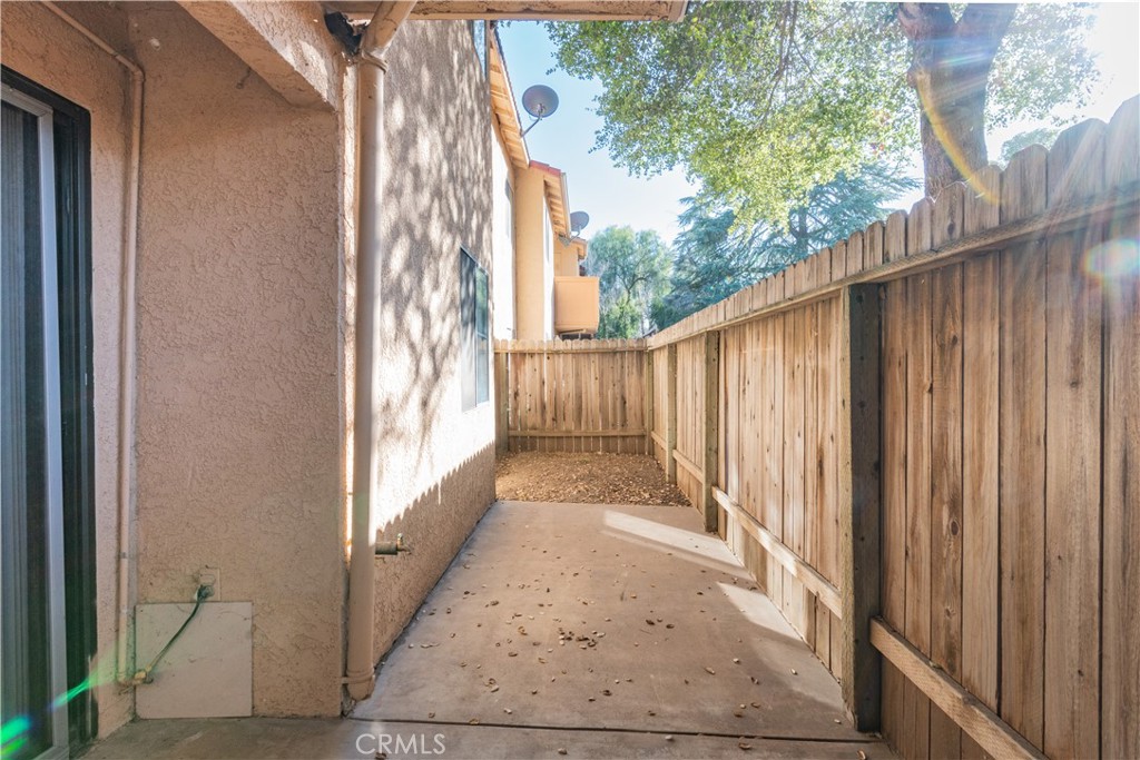 3121 Spring Street, Unit 106 Paso Robles, CA 93446 - Photo 9 of 10 a view of a pathway of a building with wooden fence