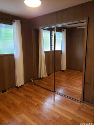 a view of a livingroom with wooden floor and a window