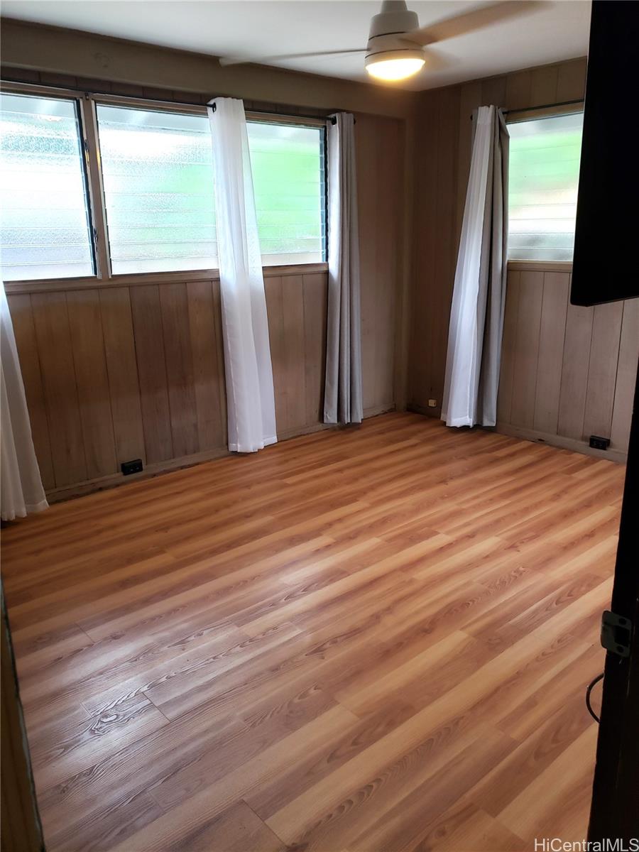 3403 Ala Ilima Street Honolulu, HI 96818 - Photo 16 of 23 a view of an empty room with wooden floor and a window