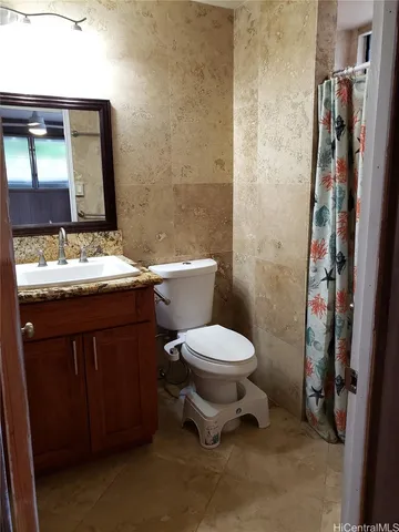 a bathroom with a toilet a sink and a mirror
